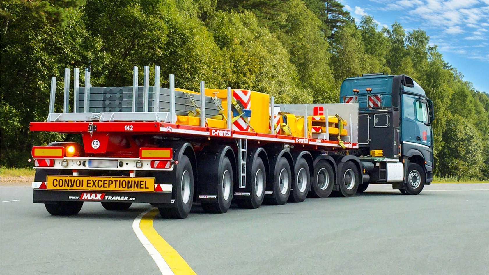 Ballast flatbed trailers transport heavy crane parts and counterweights.